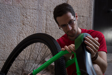 Young unicyclist fine-tuning his apparatus before taking a ride around the city of Palma (Mallorca). © Jaume Rosselló