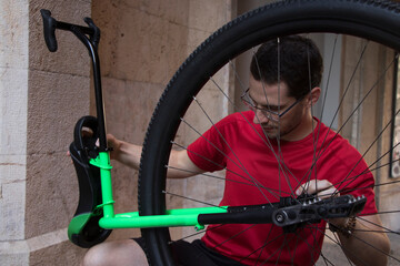 Young unicyclist fine-tuning his apparatus before taking a ride around the city of Palma (Mallorca). © Jaume Rosselló