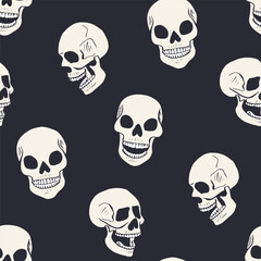 Seamless pattern with monochrome black and white hand drawn inky skulls. Skeleton heads repeat background.