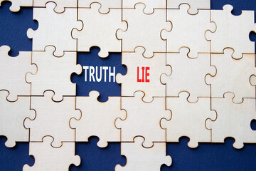 Truth or Lie symbol. Concept word Truth or Lie on wooden puzzle. Beautiful deep blue background....