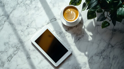 una mesa de marmol limpia  ordenada con una taza de cafe y una tableta digital para trabajar con una maceta con ramas decorativas con espacio de copia