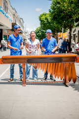 Young Latinos play their country's native instrument. Latino boys play the marimba in the middle of...