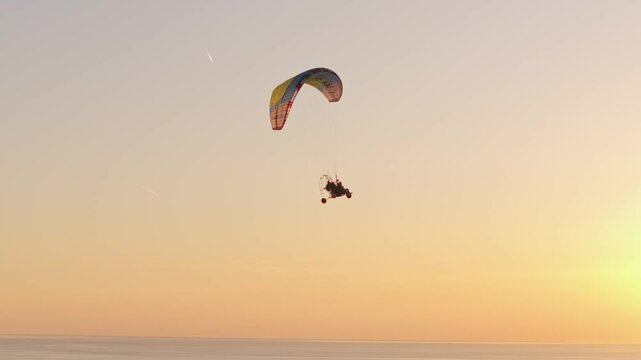 Aerial view of motor paraglider above meadows and canals, Netherlands