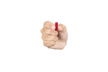 Hand holding a red pill capsule. Concept of healthcare, choice, medical treatment, or drug addiction. Taking daily vitamins or prescription medication. isolated on white background with clipping path.