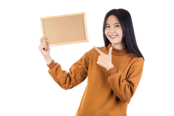 Happy smiling Asian woman holding and pointing at a blank corkboard. Perfect for your message, advertisement, or text. Presentation and announcement concept. isolated on white background with clipping