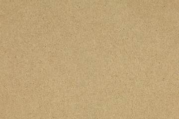 Fototapeta premium Brown kraft paper texture background. Seamless cardboard surface for design, packaging, or vintage wallpaper. Recycled material concept.