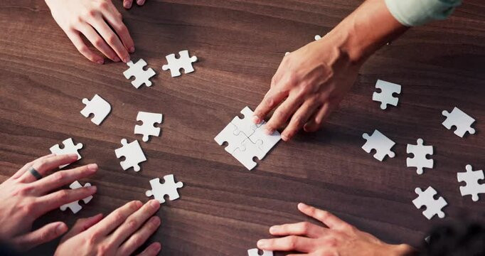 Puzzle, hands and business people in office for teamwork, solidarity and synergy for cooperation. Collaboration, top view and corporate employees with jigsaw for problem solving, challenge or unity.