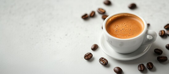 A white cup with a fragrant espresso on a saucer stands on a light surface surrounded by grains of coffee. The minimalist style and soft lighting emphasize the texture of the drink and grains.