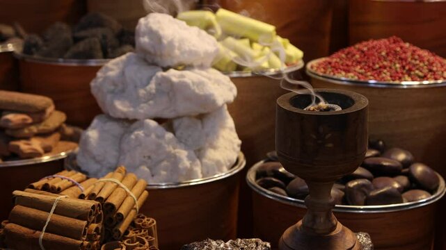 Traditional Arabic incense bukhoor agar wood burner with smoke in a spice market in Dubai