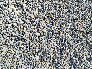 Small pebbles painted in white, texture.