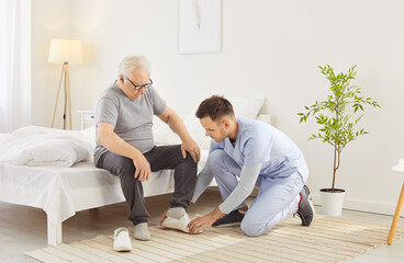 Senior retirement house old resident and young brother helping to put shoes, nursing for help,...