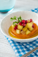 Sweet potato puree topped with fruit cubes and pomegranate