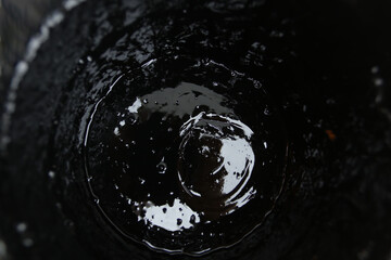 Bubbles forming at the bottom of a glass as water drains away during a warm afternoon in a cozy cafe