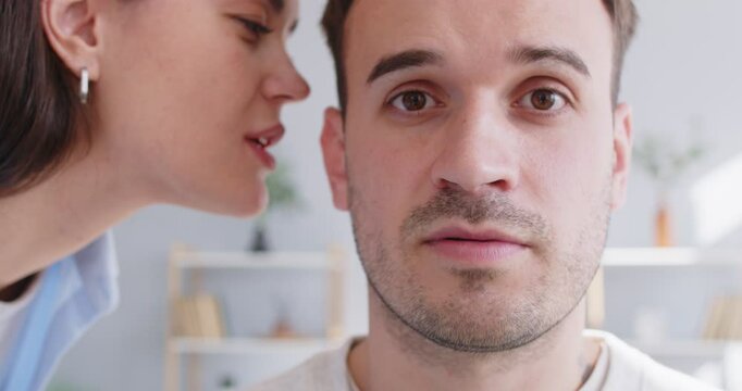 Chatty woman, talkative wife telling secret to man, husband, whispering at ear, family communication chatting, having fun, sharing hearing, rumor, good trust family relationship, new positive message