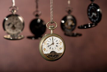Pocket watch, beautiful and antique pocket watches hanging in front of an abstract background,...