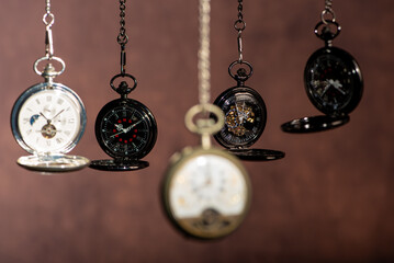 Pocket watch, beautiful and antique pocket watches hanging in front of an abstract background,...