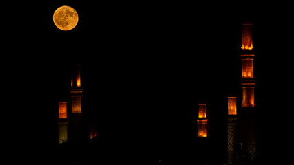 Full Moon Over Illuminated Mosque Minarets at Night