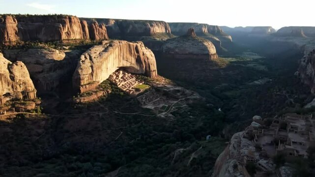 Majestic canyon de chelly national monument cliff dwellings bathed in golden hour sunlight showcasing ancient ancestral puebloan history