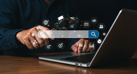 Person holding a magnifying glass over a search bar with icons around it and a laptop next to it
