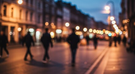 Blurred view of people walking on a city street at night, illuminated by streetlights and building lights.