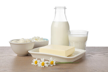 Different fresh dairy products and chamomile flowers on wooden table against white background