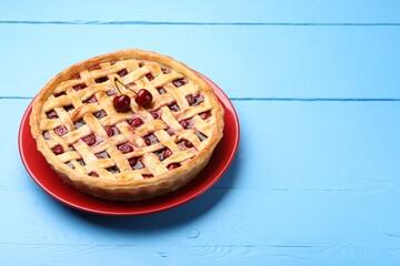 Tasty cherry pie on light blue wooden table, space for text