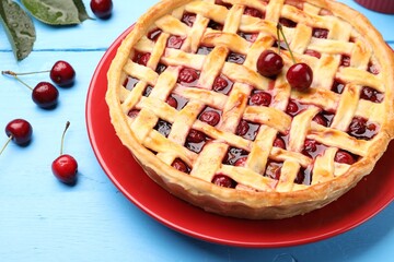 Tasty cherry pie on light blue wooden table, closeup