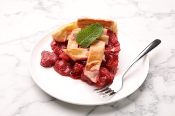 Piece of tasty strawberry pie on white marble table, closeup