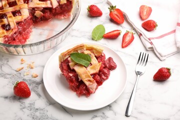 Piece of tasty strawberry pie and berries on white marble table, closeup
