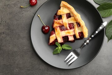Piece of tasty cherry pie and berries on grey table, flat lay. Space for text