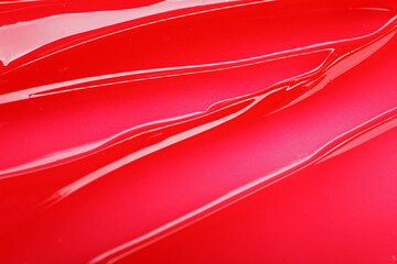 Texture of red lip gloss as background, top view