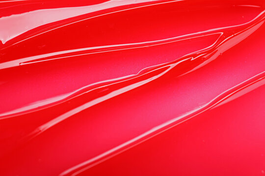 Fototapeta Texture of red lip gloss as background, top view