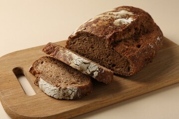 Pieces of fresh rye bread on beige background, closeup