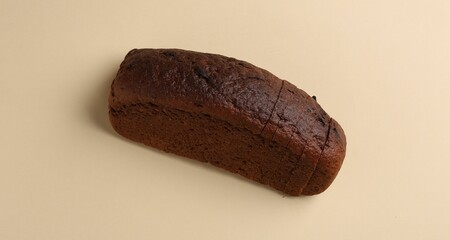 Fresh rye bread on beige background, above view