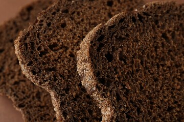 Pieces of fresh rye bread as background, closeup