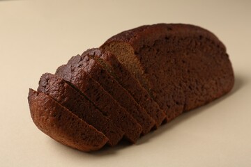 Pieces of fresh rye bread on beige background, closeup