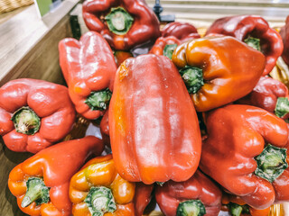 A bunch of red peppers are piled on top of each other