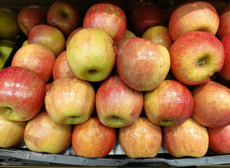 A pile of apples with stickers on them