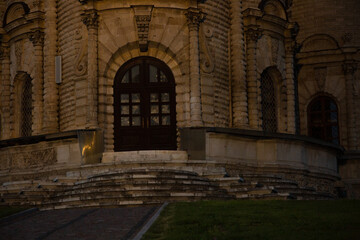 Beautiful entrance door to baroque medieval style old church building on nature bright evening...