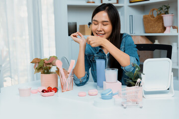Young beautiful Asian girl reviewing moisturizing body lotion cream product to make glow skin...