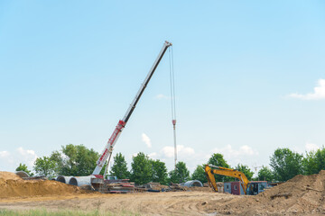 Construction site on the background of the sky. Construction machinery is working to create the...