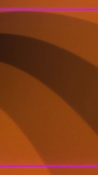 Animation of game controllers, shapes, icons and pink frame over flashing orange stripes