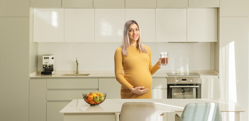 Pregnant woman holding a glass of water