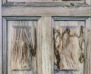 The wood paneling on the door is old and worn