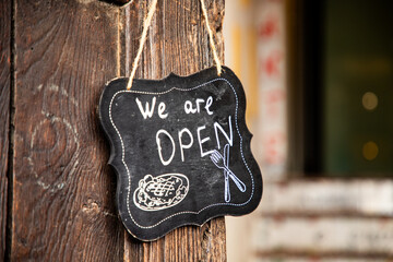 we are open sign on restaurant door