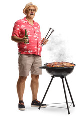 Full length portrait of a mature man with a bbq tong and a bottle of beer grilling meat