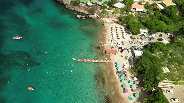 Wide shot of Playa Piskado beach with boats anchored and crowds enjoying the sun.
Use in tropical lifestyle videos or Caribbean destination promos. Filmed 1 June 2025, playa Piskado, Curacao