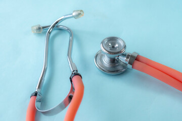 Close up of medical-themed composition featuring stethoscope on blue background. Perfect for illustrating healthcare, diagnostics, or cardiology-related concepts.
