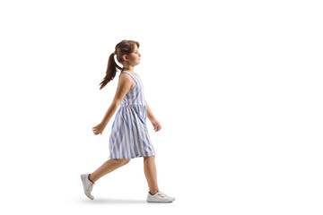 Full length profile shot of a girl in a dress walking