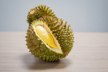 Durian fruit with cut in half on wooden table